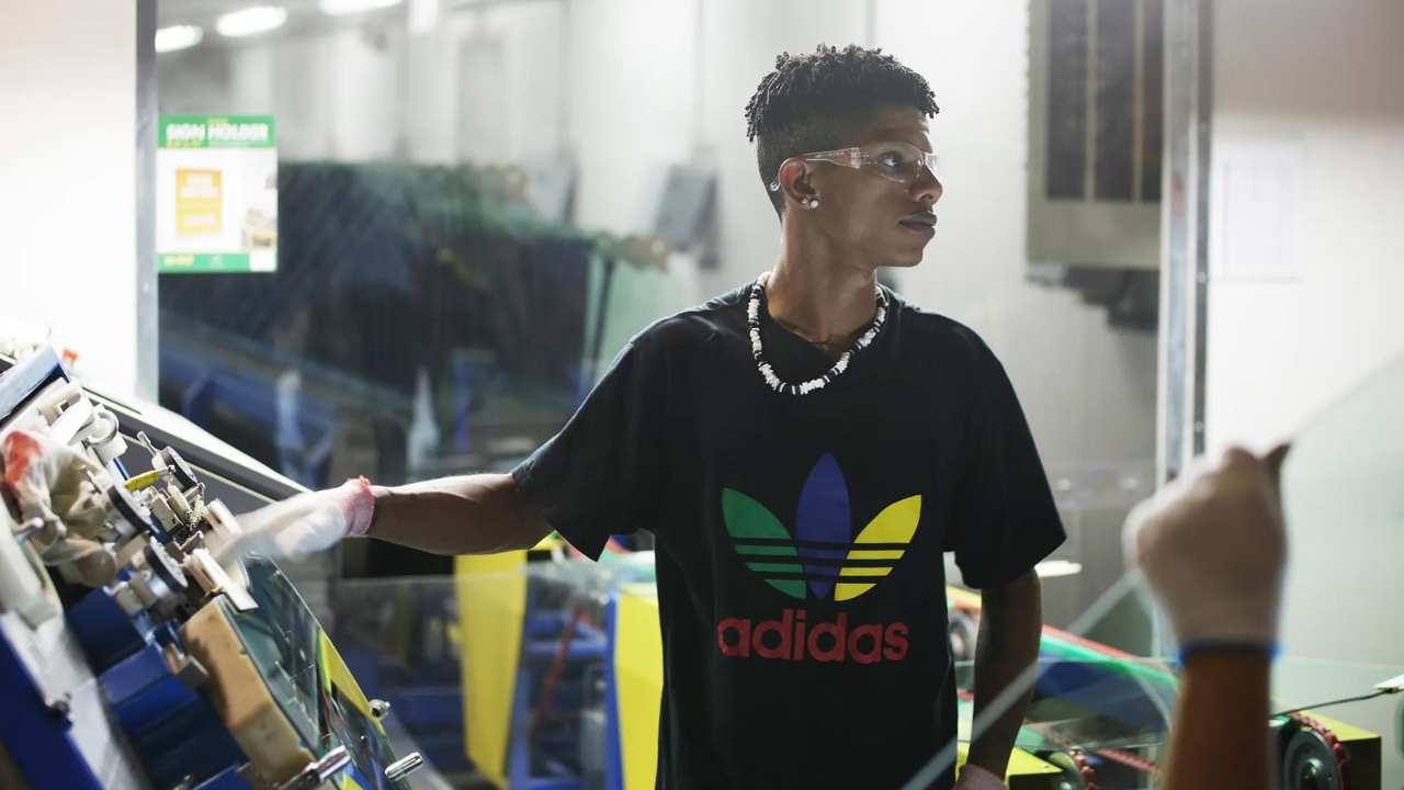 a man wearing safety goggles and an Adidas t-shirt